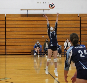 Senior Alissa Laage (#12) sets up a teammate for a spike attempt at the net for the Weston volleyball team in its home opener vs. LaFarge last week at Weston High School. Weston led the match 2-0 but lost the next three sets and the match to the Wildcats. (Photo by Troy Matz)