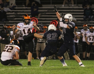 Senior Zach Bestor (No. 22) breaks through to block this Portage FG attempt in the second half for the Beaver football team in the season opener Friday night at Millennium Field. Bestor and the Beavers lost in OT, 13-7. (Photo by Troy Matz)