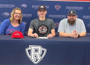 Senior Connor Adams, middle, is joined by his parents in announcing that he’ll play for Western Tech in La Crosse in college baseball next season. (School District of Reedsburg photo)